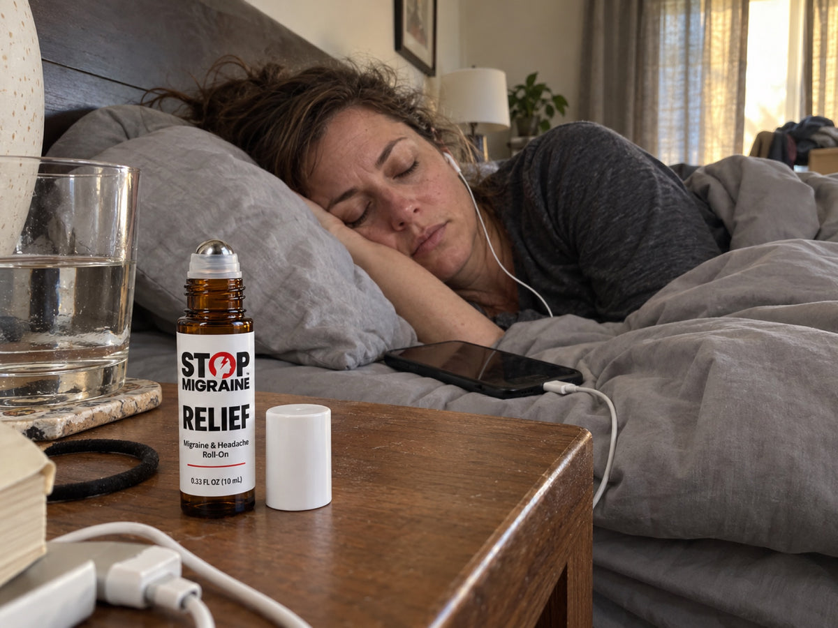 Woman resting in bed with earbuds, STOP MIGRAINE RELIEF roll-on on the nightstand